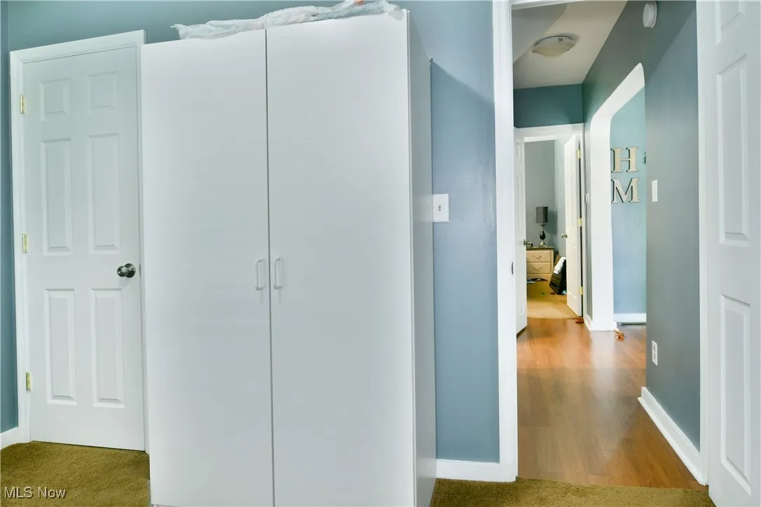 Hall featuring baseboards and wood finished floors