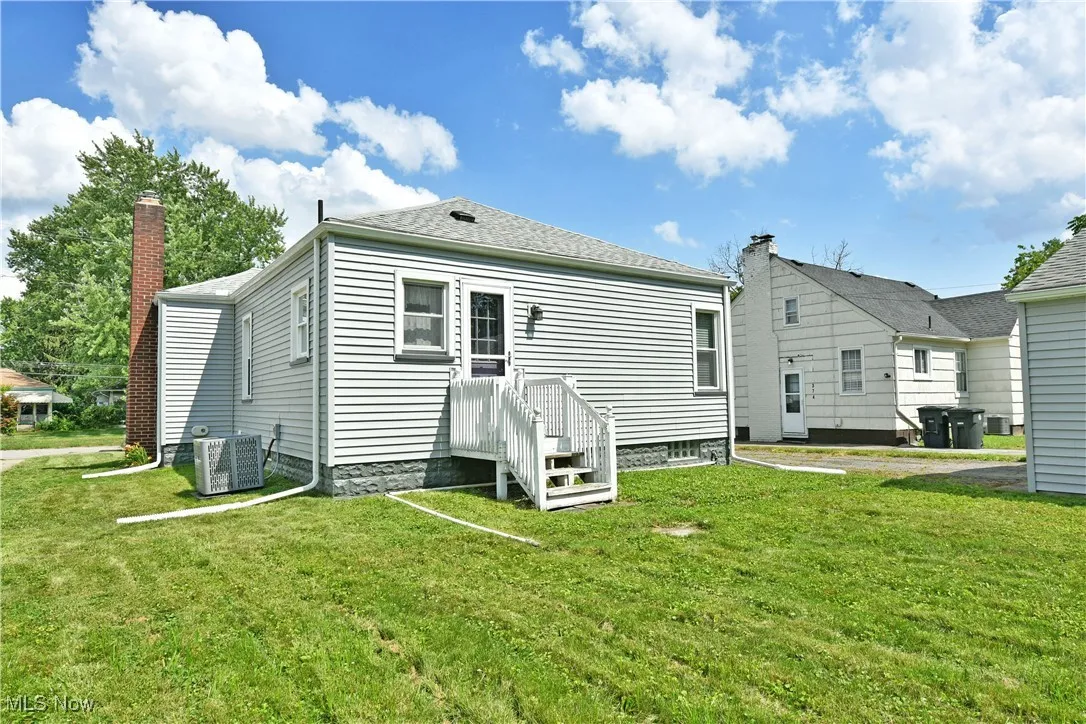 Rear view of house featuring a yard