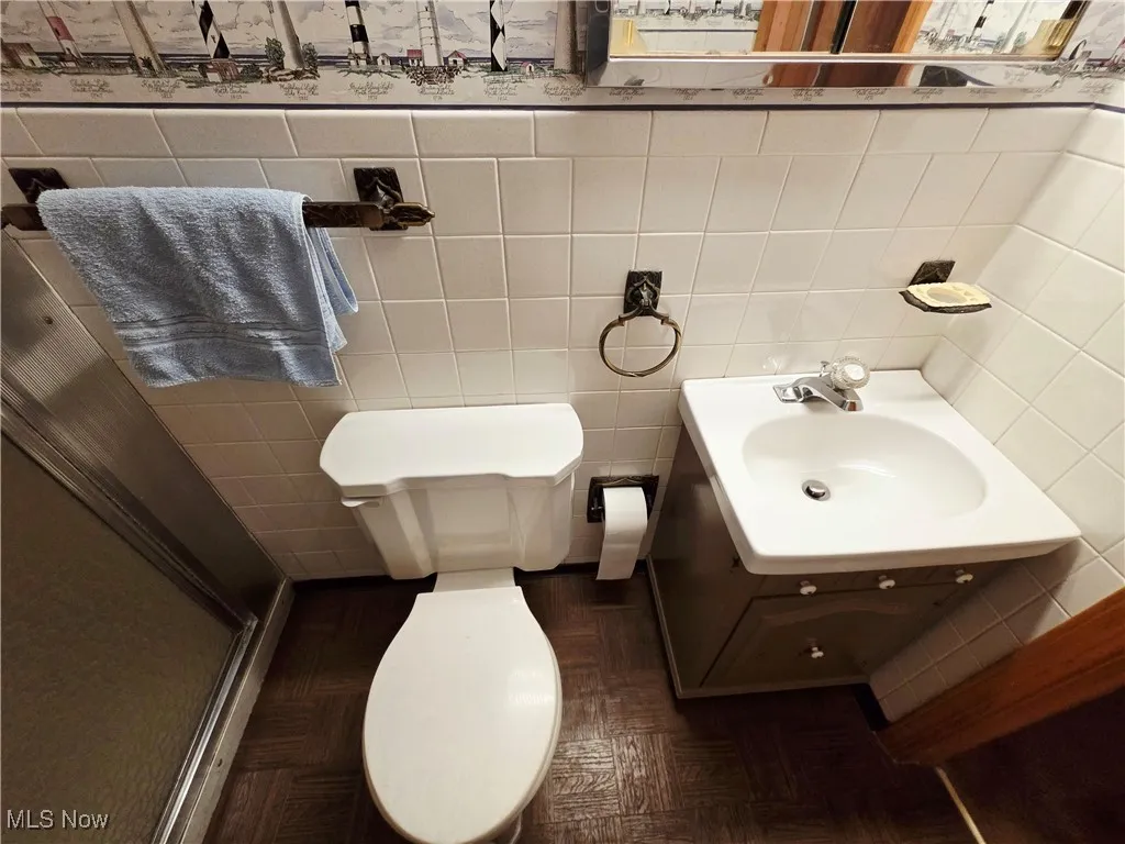 Bathroom with vanity and tile walls