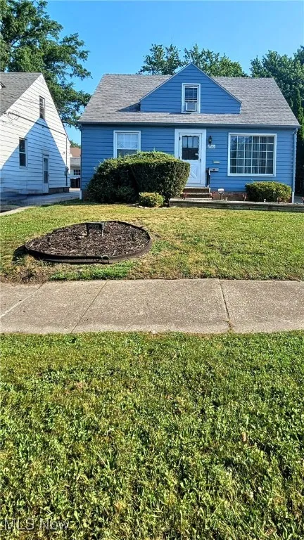 Bungalow-style house with a front lawn
