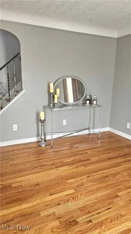 Detailed view of wood finished floors and a textured ceiling