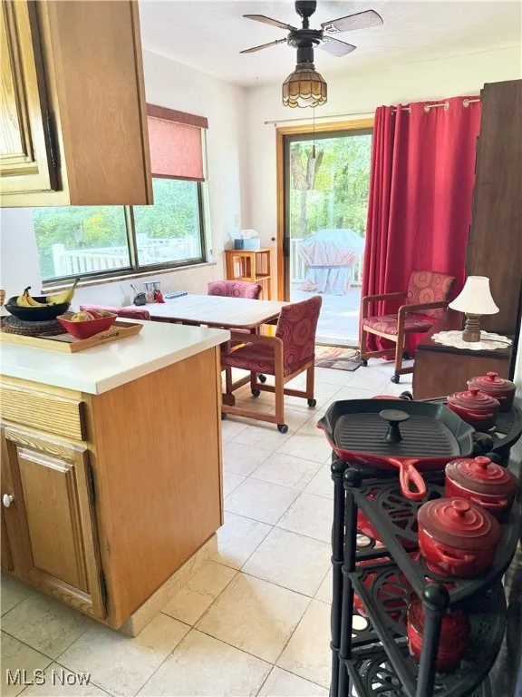 Kitchen featuring a ceiling fan, light countertops, and light tile patterned floors