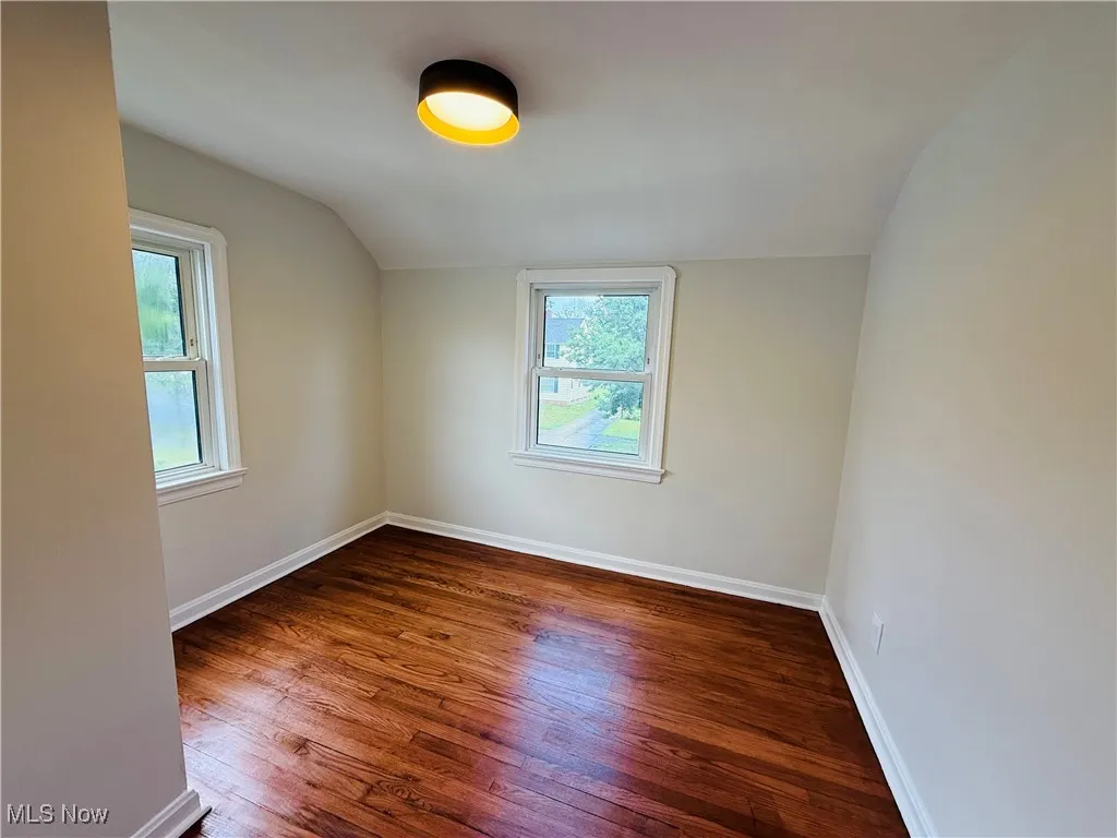 Bonus room with lofted ceiling and wood finished floors