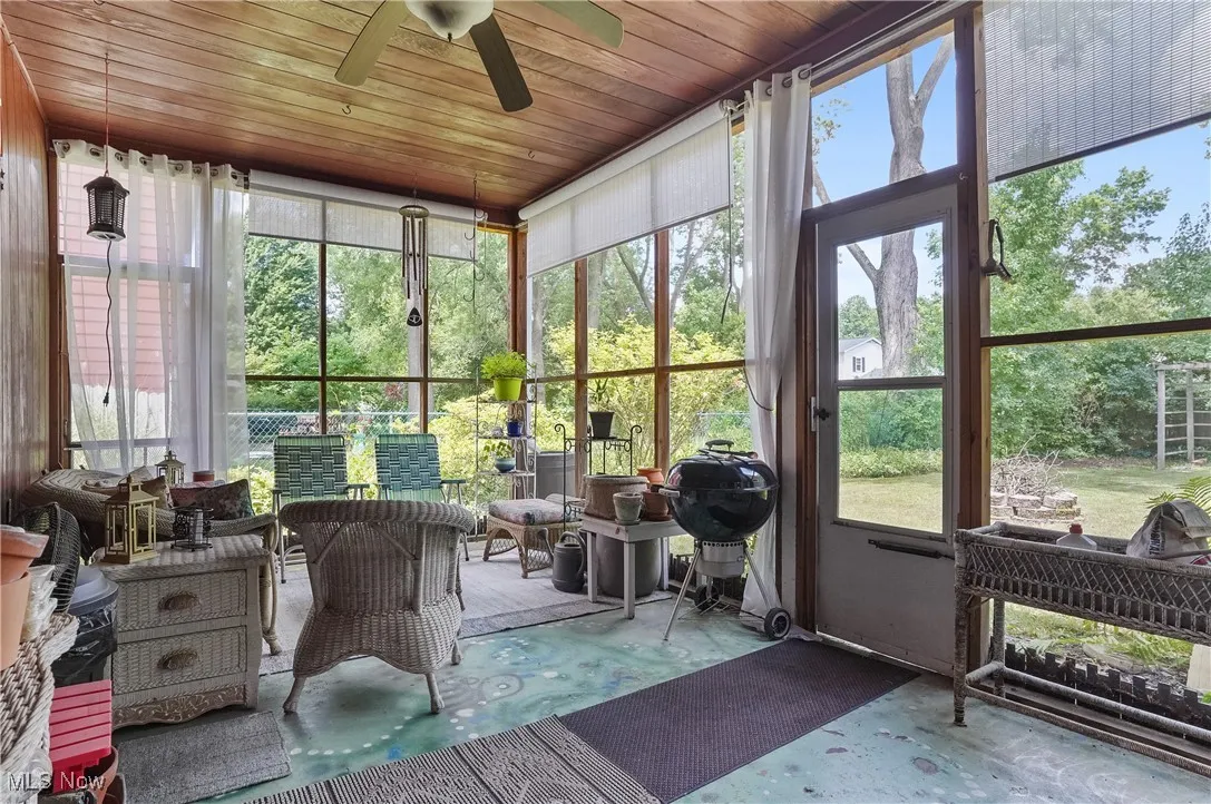 Sunroom featuring ceiling fan and healthy amount of natural light