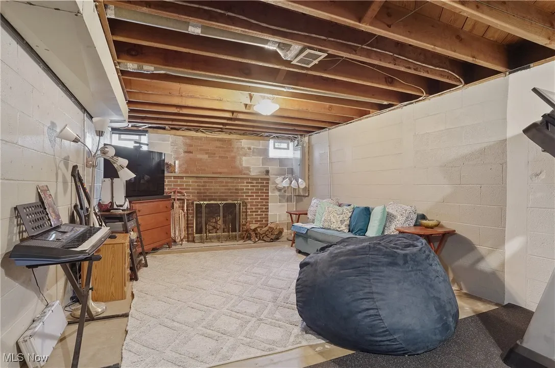Recreation room featuring a brick fireplace
