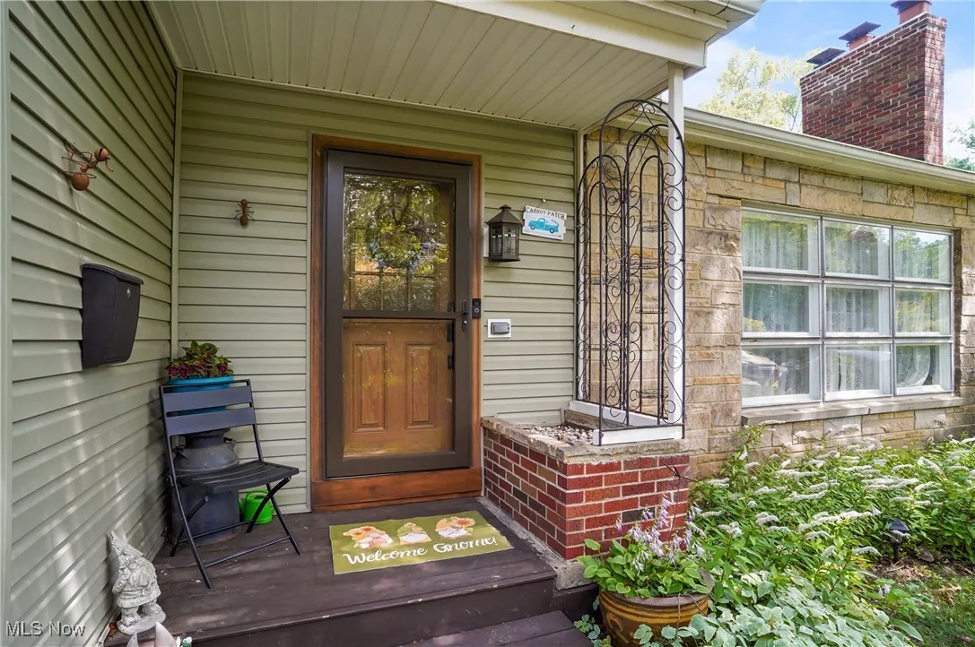 Entrance to property featuring stone siding
