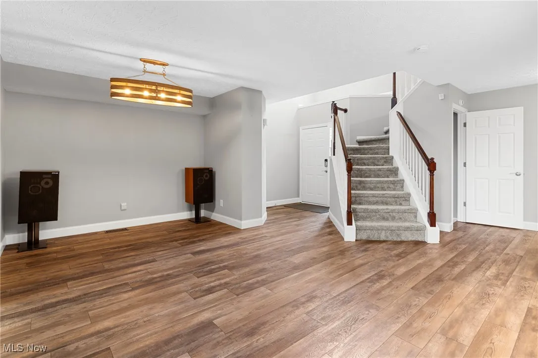 Basement with wood finished floors and stairway
