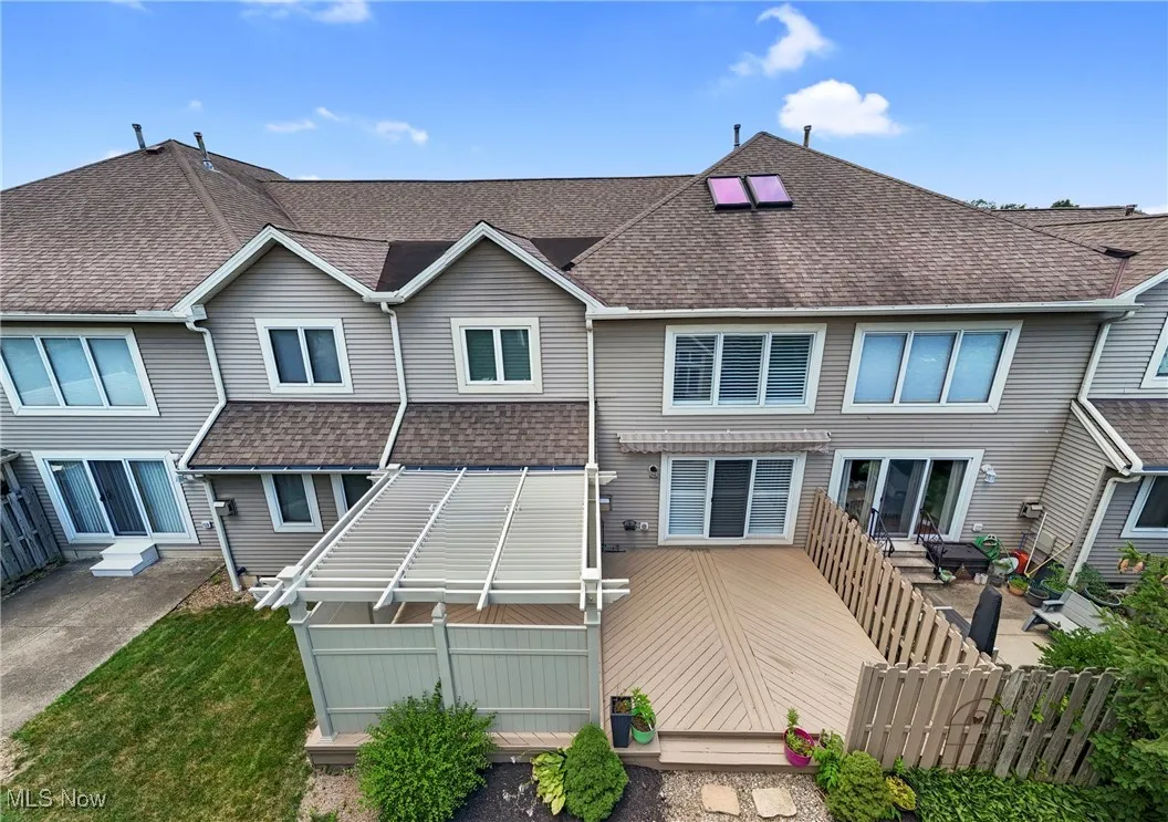 Rear view of property with a shingled roof