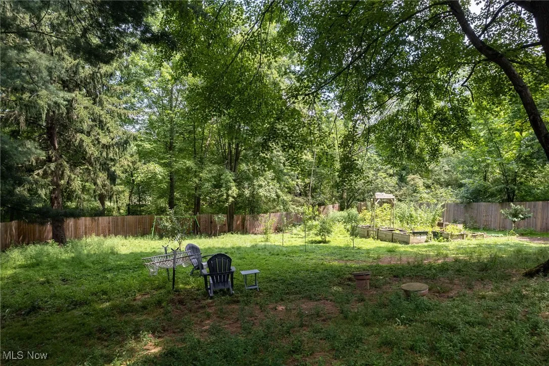 Fenced backyard with a vegetable garden