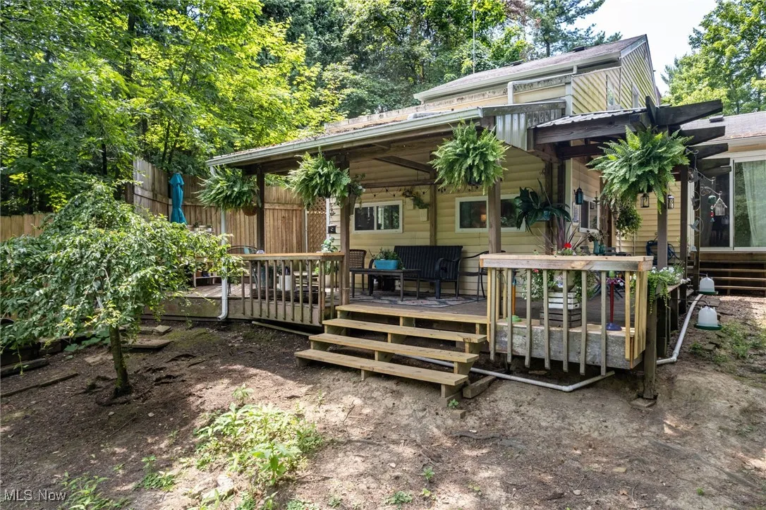 Rear view of property featuring a wooden deck