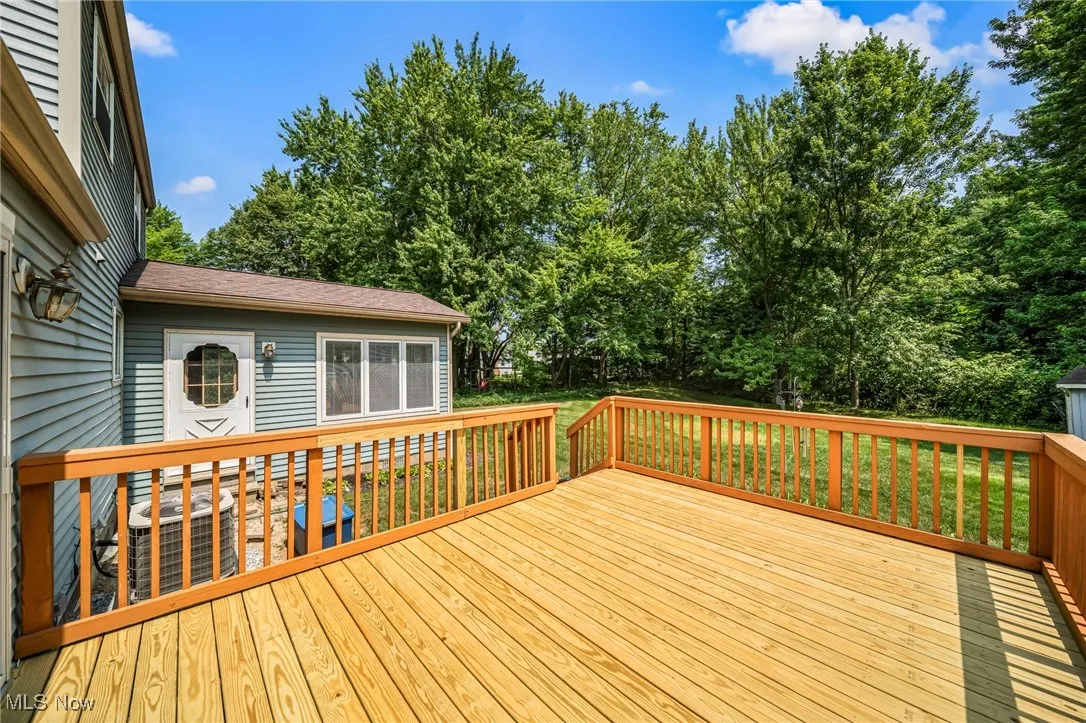 Wooden deck featuring view of scattered trees