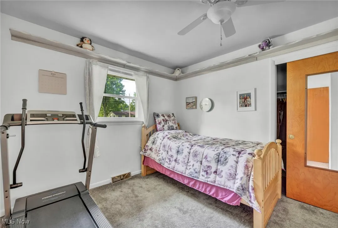 Bedroom with carpet floors and a ceiling fan