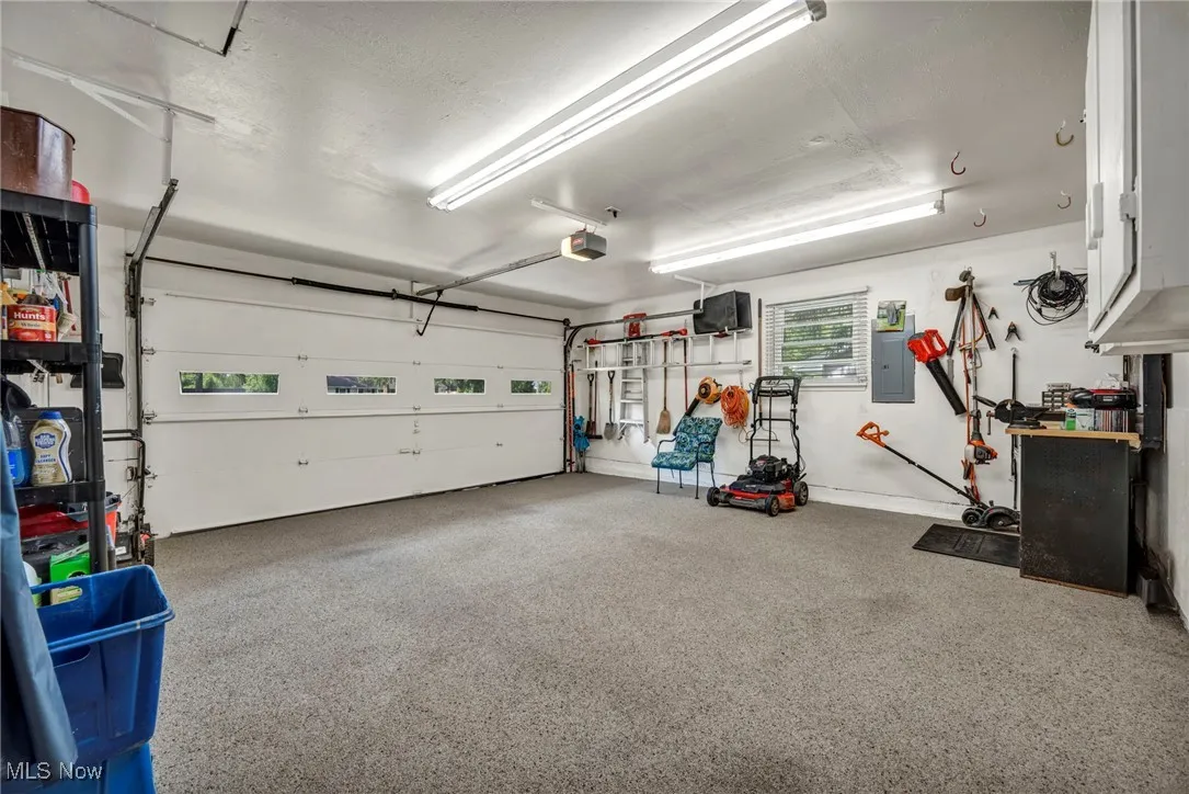 Garage with a garage door opener and electric panel