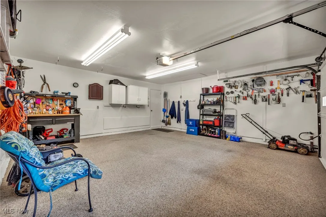 Garage with a workshop area and a garage door opener