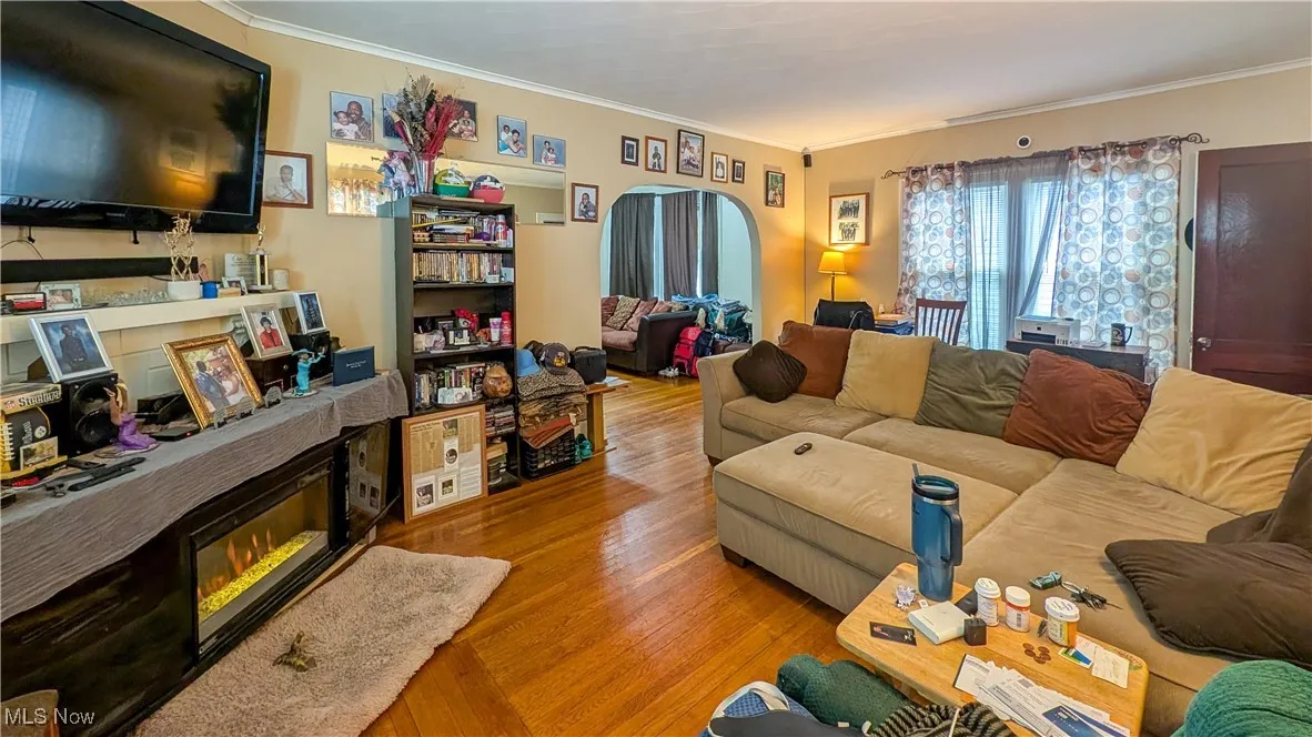 Living area featuring ornamental molding and wood finished floors