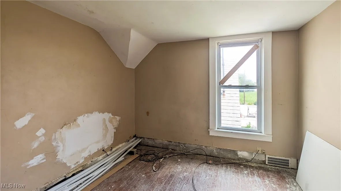 Bonus room featuring vaulted ceiling and wood finished floors