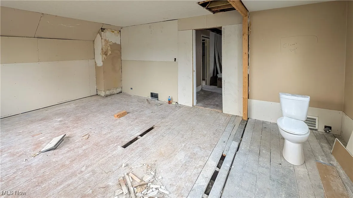 Bathroom with toilet and wood finished floors