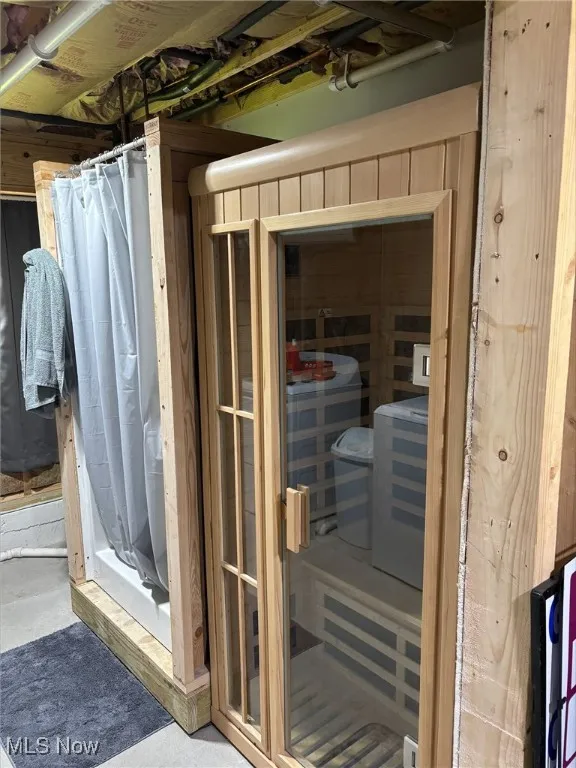 Sauna featuring concrete flooring
