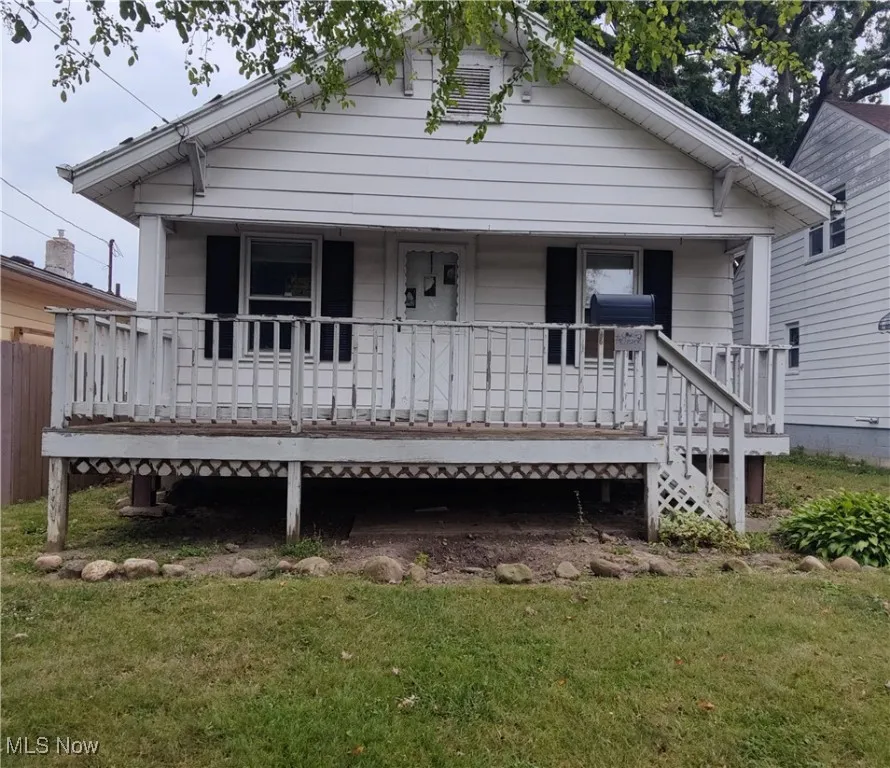 View of front of home featuring a porch and a front lawn