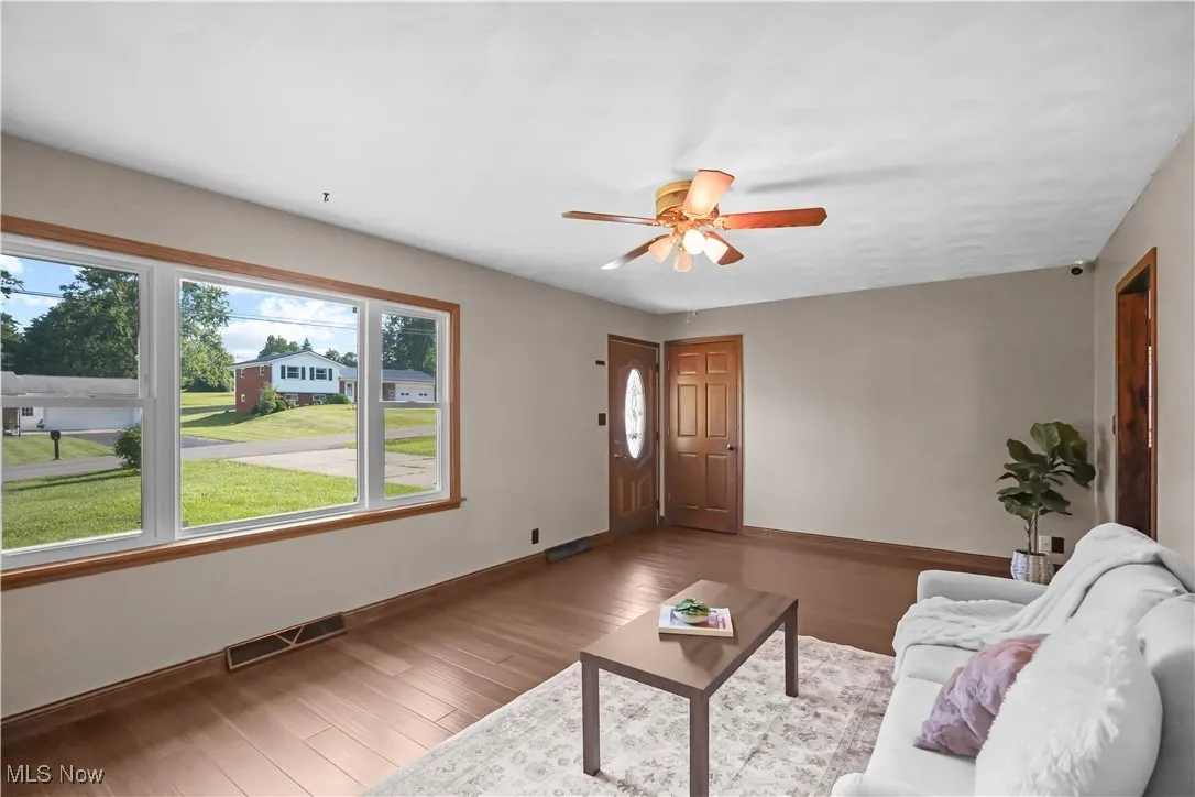 Living area featuring ceiling fan and wood finished floors