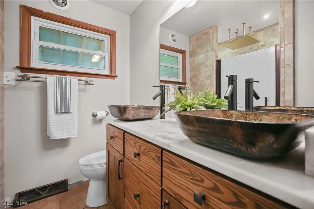 Bathroom featuring vanity and tile patterned floors