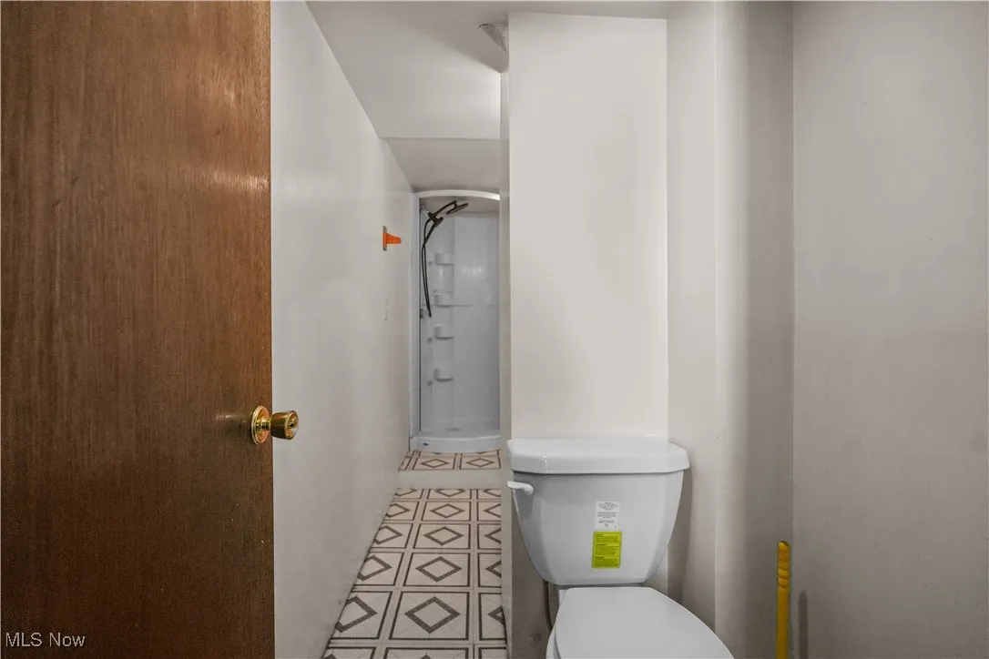 Bathroom featuring tile patterned flooring and a shower