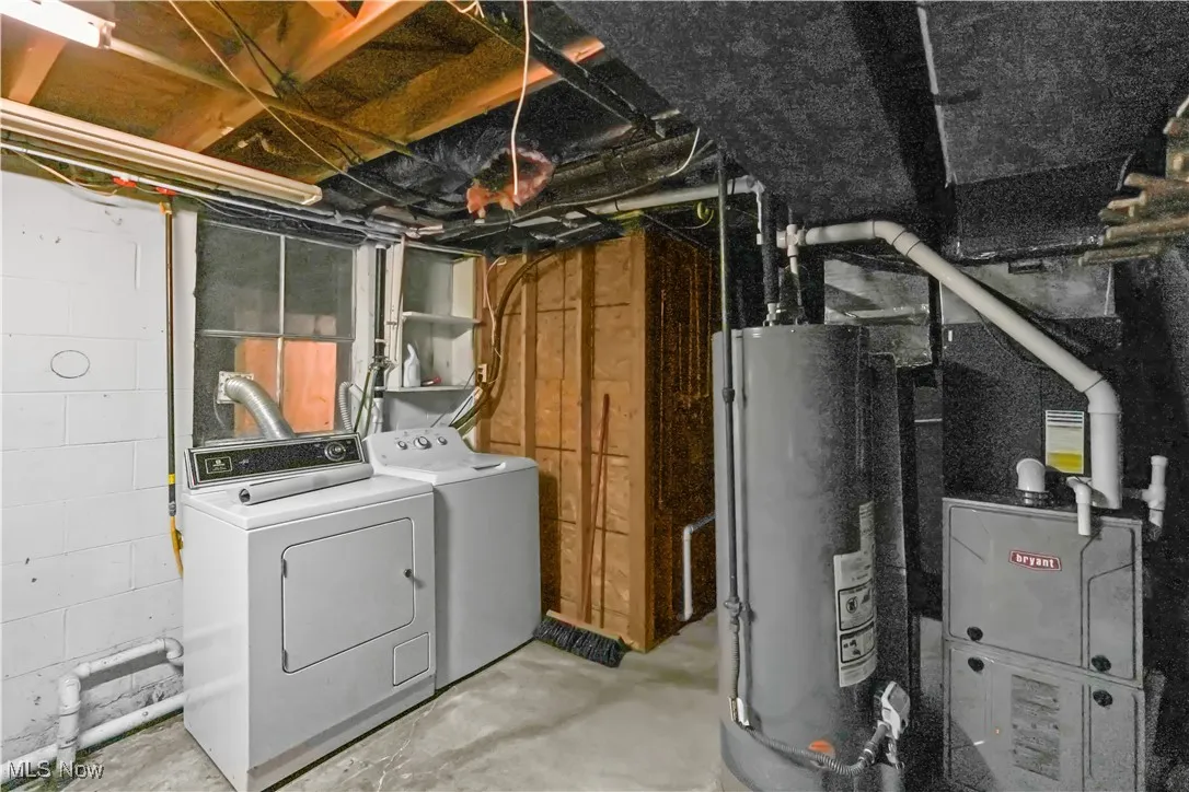 Unfinished below grade area with gas water heater and washer and dryer
