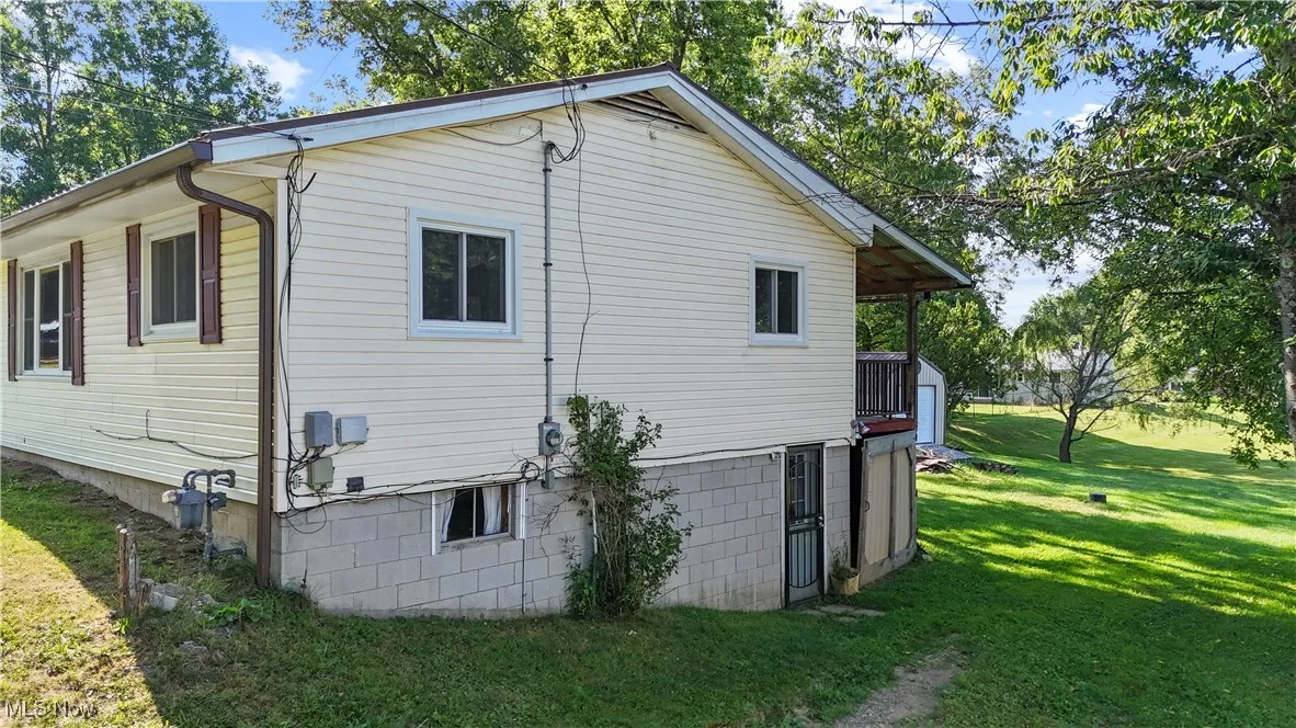 View of home's exterior with a yard
