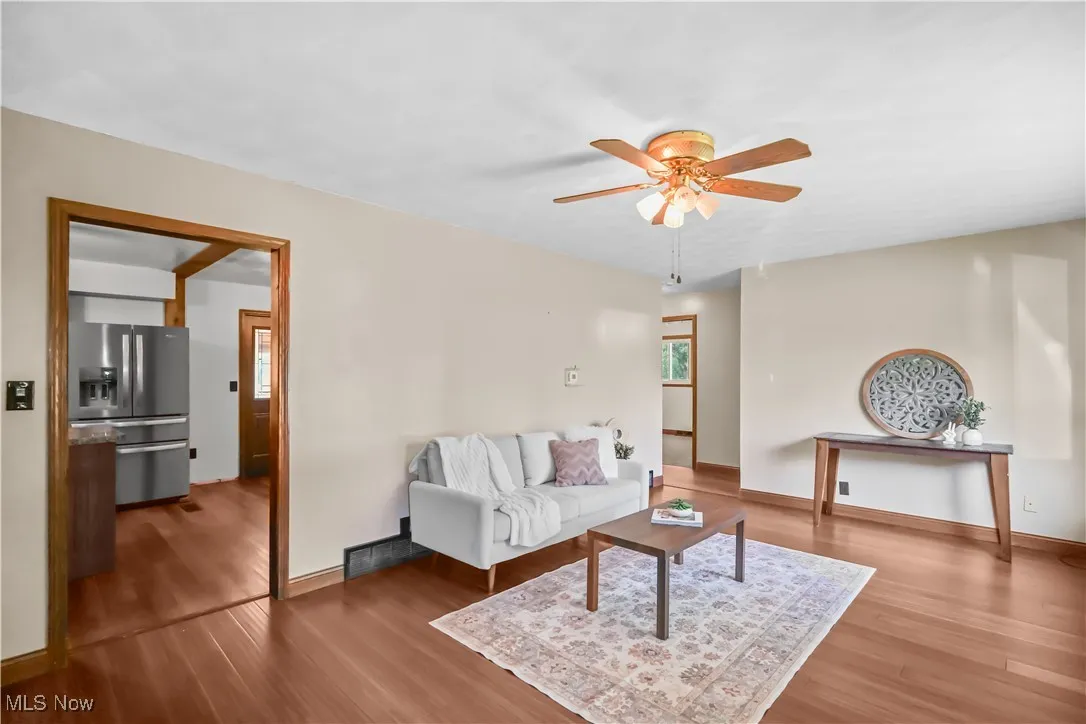 Living area featuring ceiling fan, wood finished floors, and healthy amount of natural light