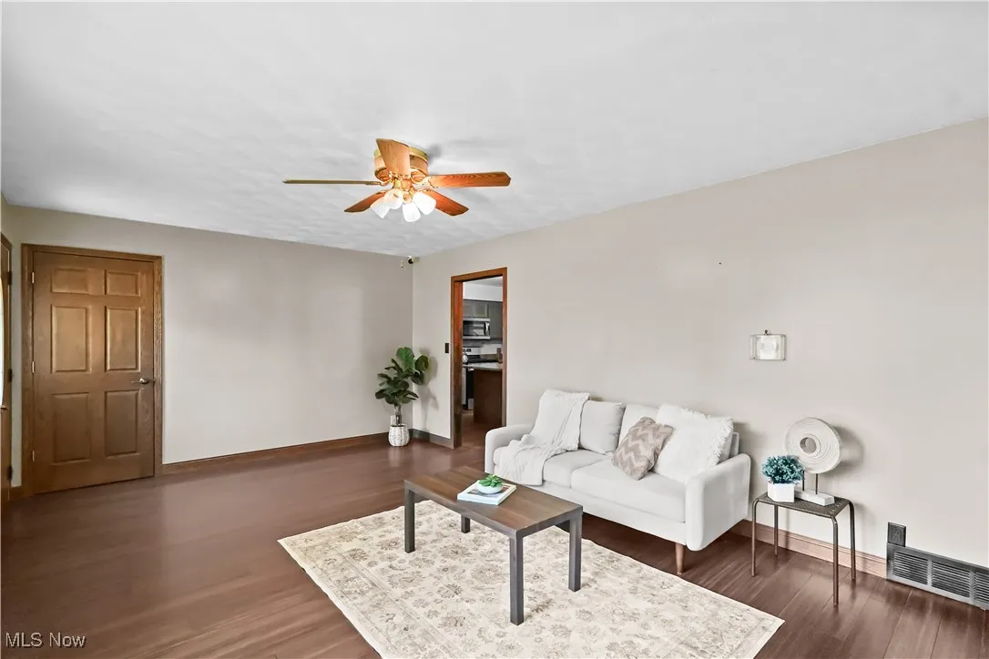 Living area featuring a ceiling fan and wood finished floors