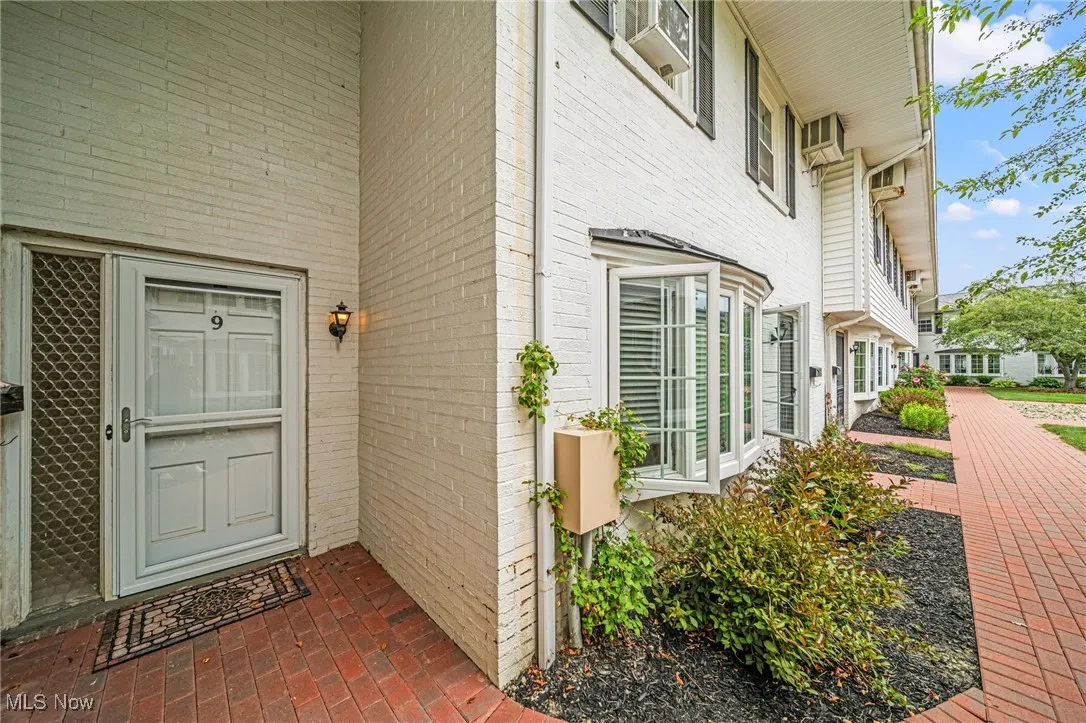View of exterior entry featuring brick siding