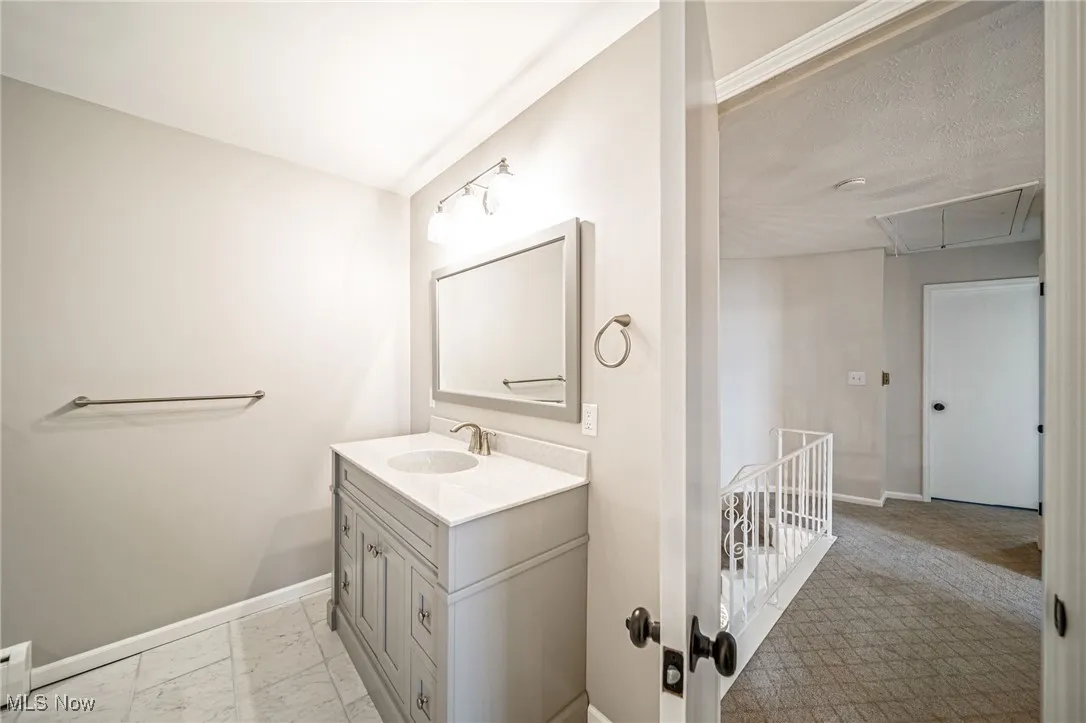 Bathroom featuring vanity and marble finish floors