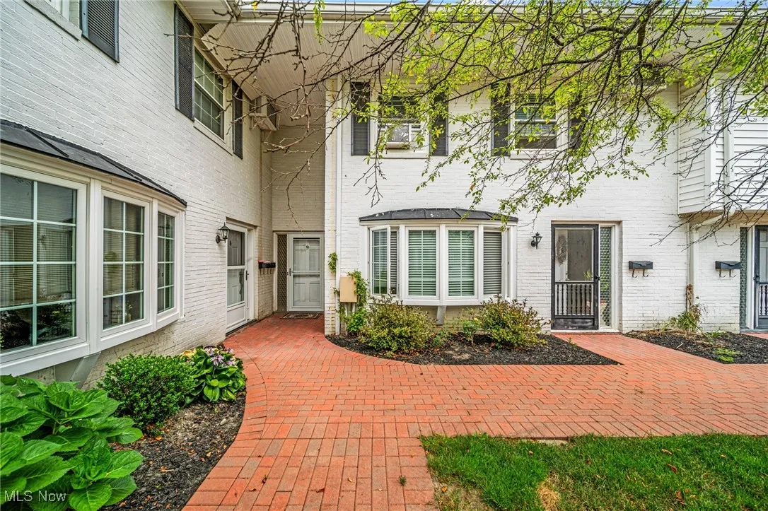 Doorway to property with brick siding