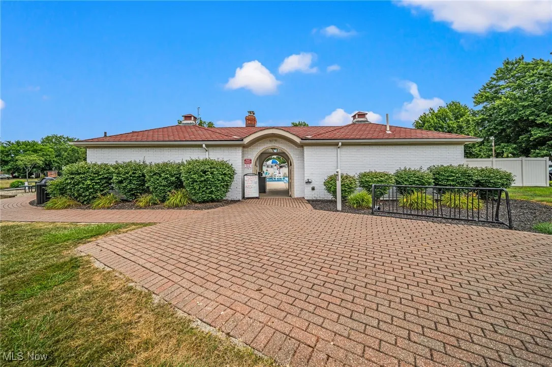 Ranch-style home with brick siding and a chimney