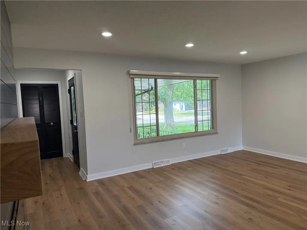Unfurnished room featuring wood finished floors and recessed lighting