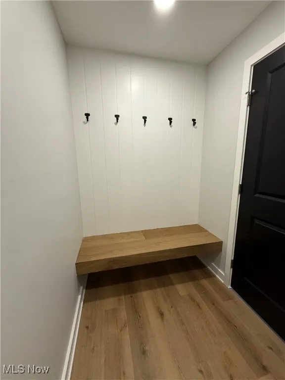 Mudroom featuring wood finished floors and baseboards