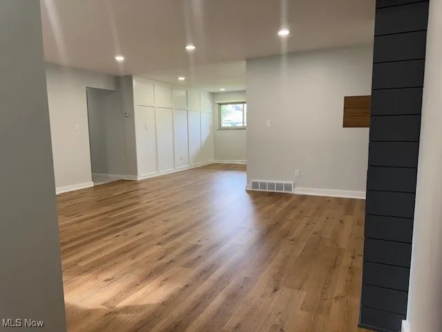 Empty room with recessed lighting and light wood-style floors