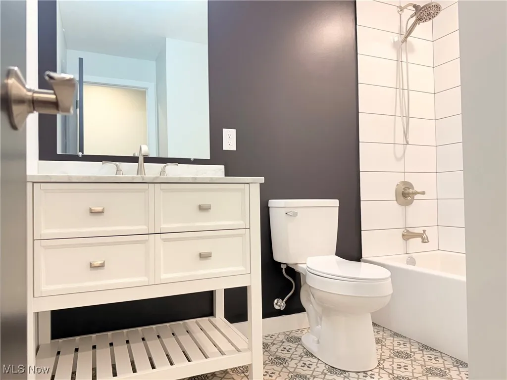 Bathroom with vanity and bathing tub / shower combination
