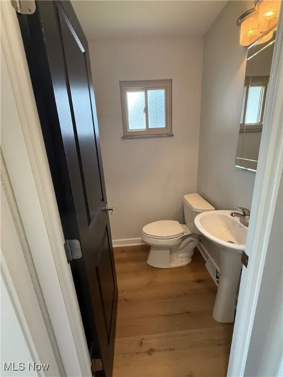 Bathroom featuring toilet and wood finished floors