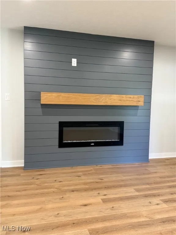 Detailed view of a large fireplace and wood finished floors