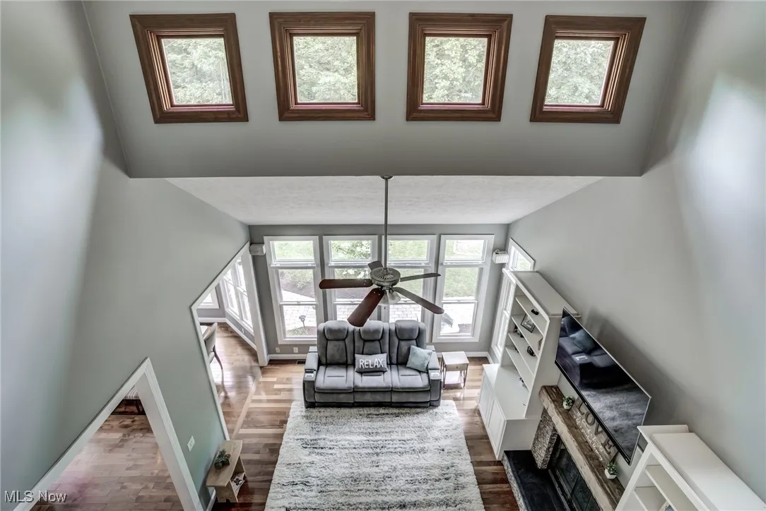 Living area featuring wood finished floors and a ceiling fan