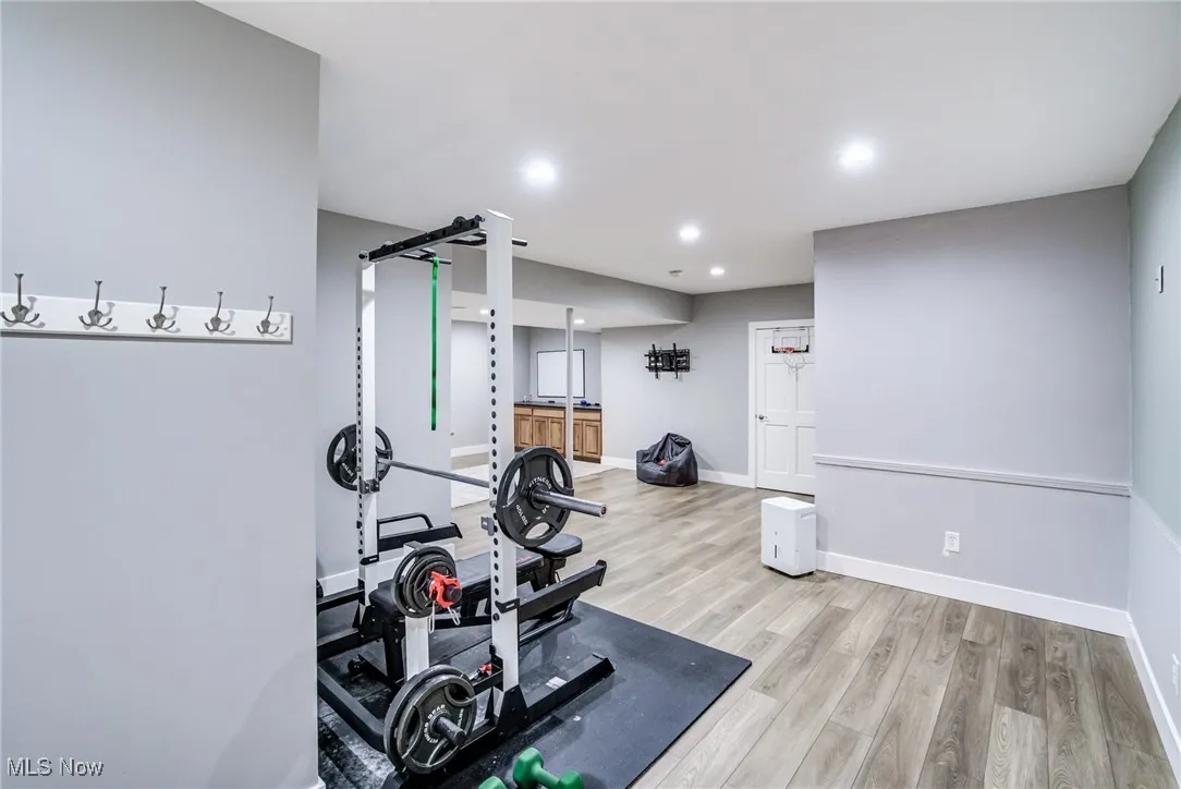 Workout room featuring light wood-type flooring and recessed lighting