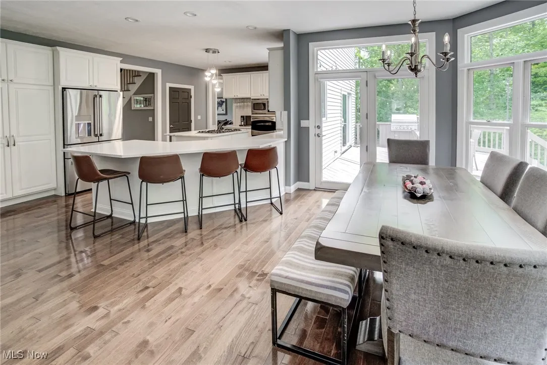 Dining space featuring a chandelier, light wood-style floors, and recessed lighting
