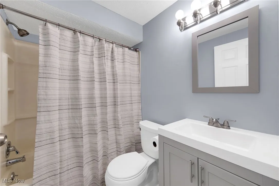 Full bathroom with vanity and shower / bath combo