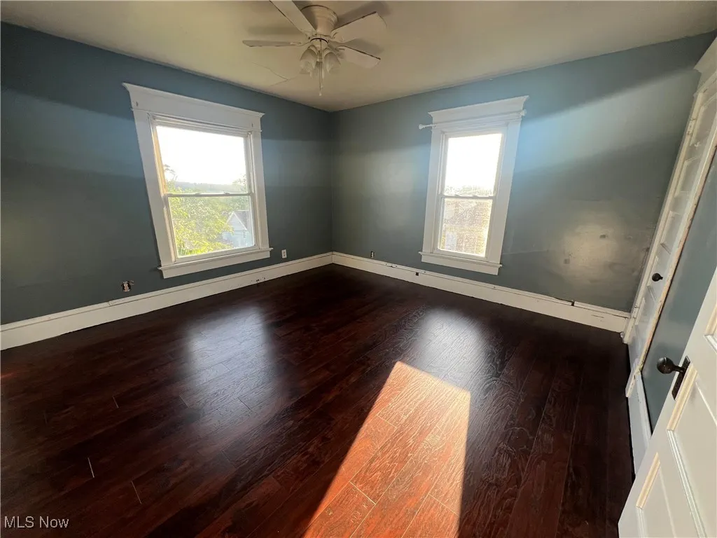 Spare room featuring hardwood / wood-style floors and ceiling fan