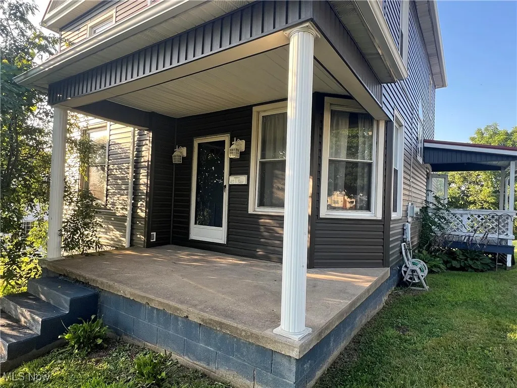 View of exterior entry with a porch