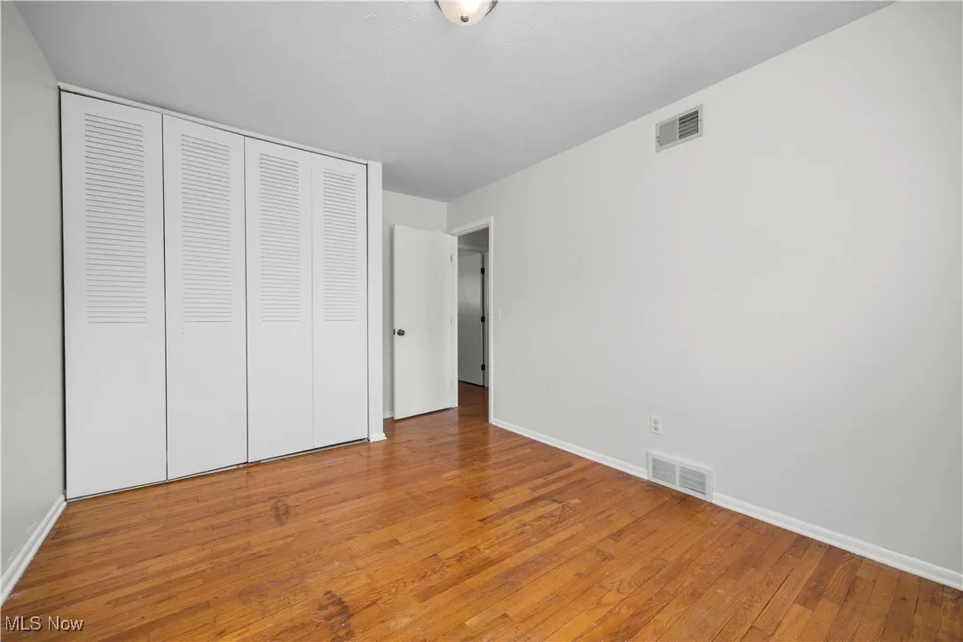 Unfurnished bedroom with light wood-type flooring and a​​‌​​​​‌​​‌‌​‌‌​​​‌‌​‌​‌​‌​​​‌​​ closet