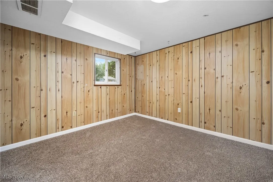 Recreation roomy featuring wooden walls