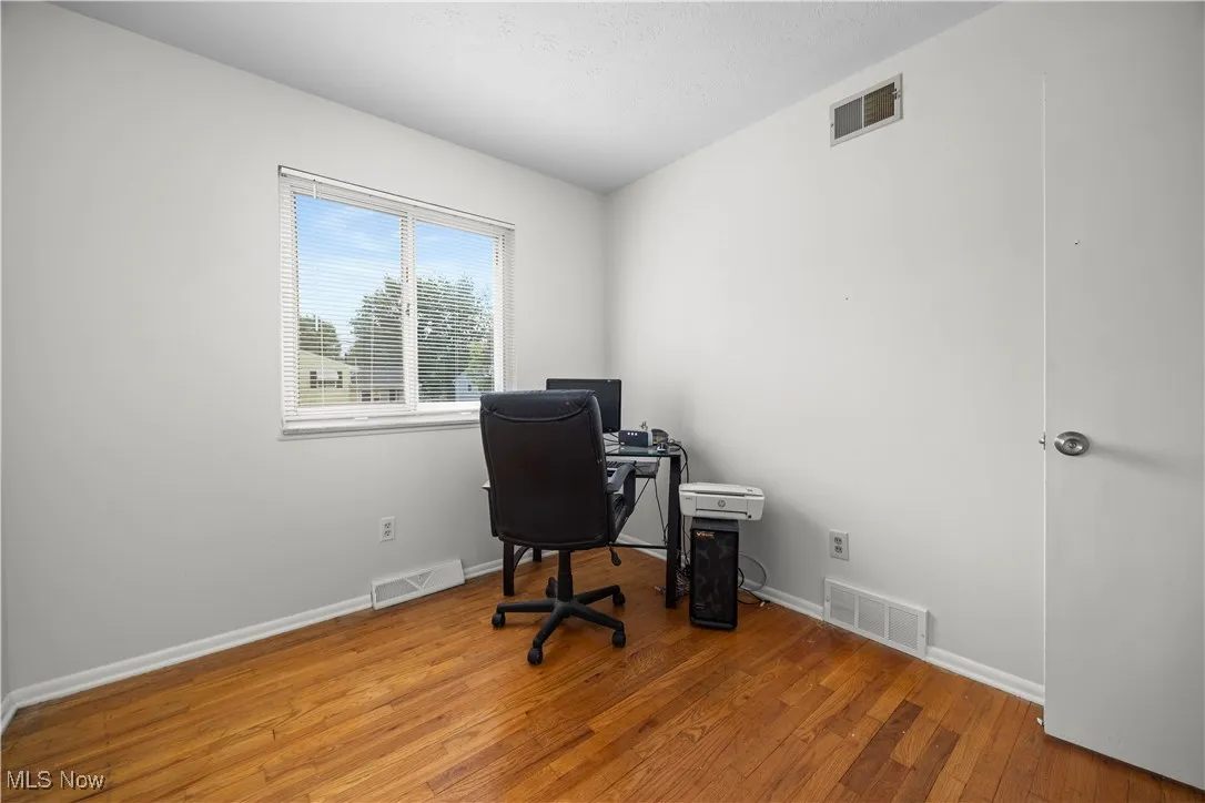 bedroom area with wood finished floors and baseboards