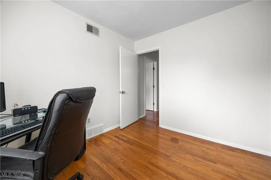 bedroom featuring wood finished floors and baseboards